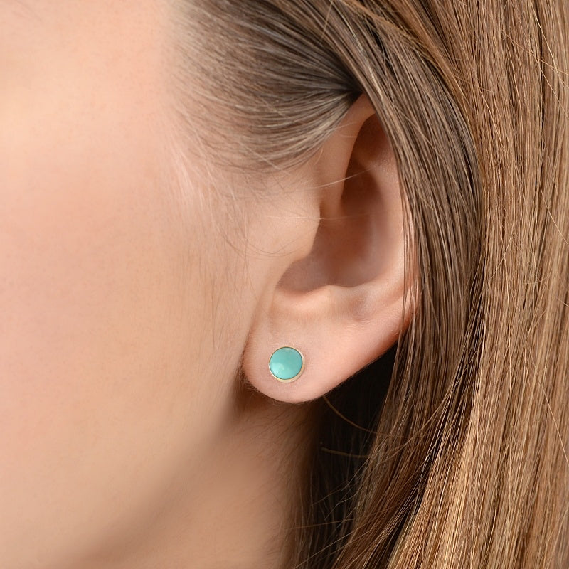 Kingman Turquoise earrings on ear 14ct gold