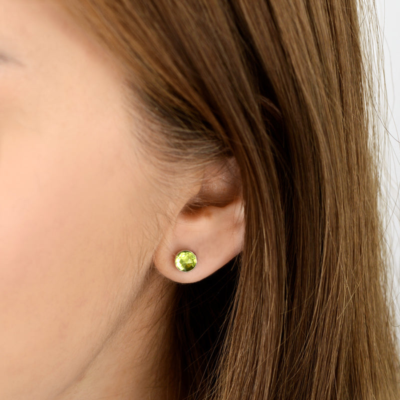 peridot earrings on ear